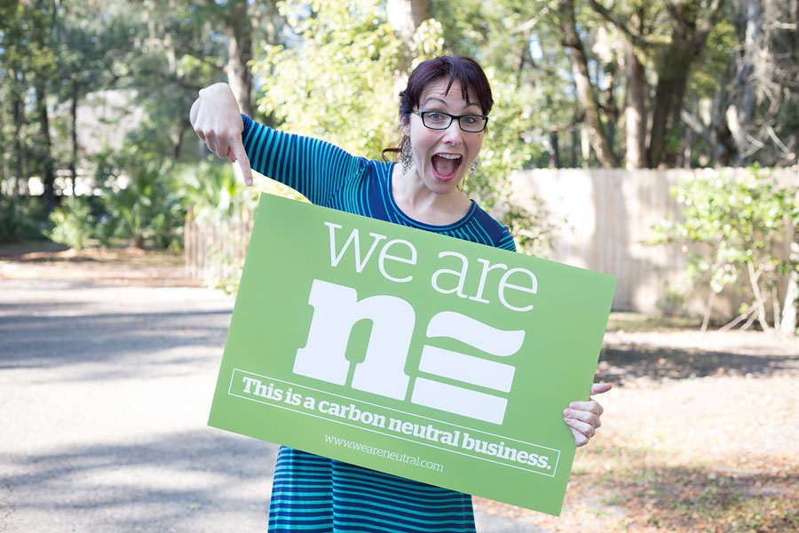Adrienne Fletcher Photography's owner holding a We are Neutral sign